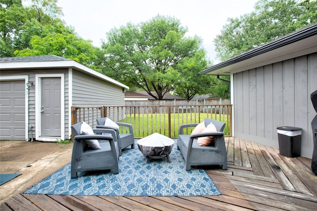 deck with an outdoor fire pit, fence, and a lawn