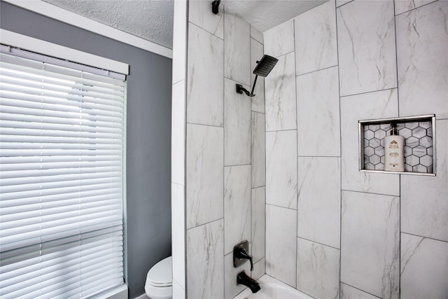 full bathroom with a textured ceiling, shower / bathtub combination, and toilet