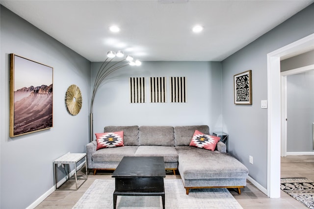 living area with recessed lighting, light wood-style flooring, and baseboards