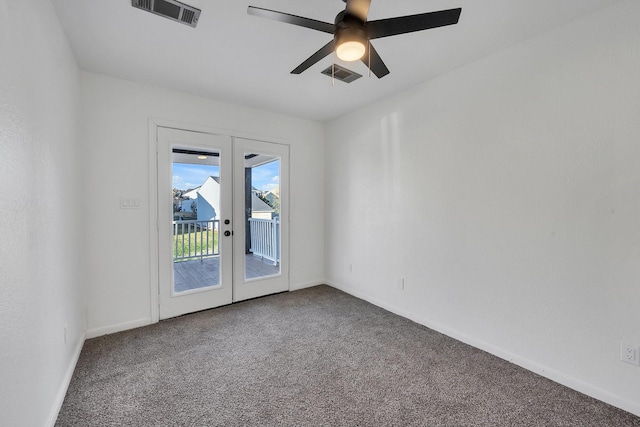 carpeted spare room featuring french doors, visible vents, ceiling fan, and baseboards