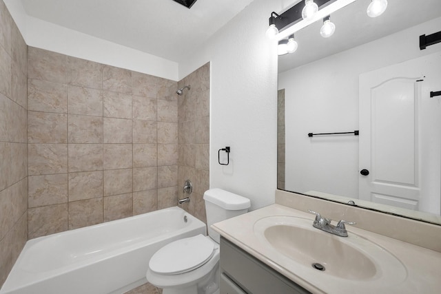 bathroom with washtub / shower combination, vanity, and toilet