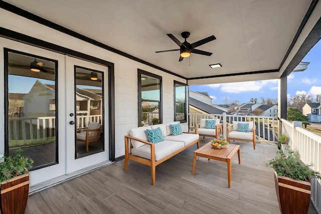 wooden deck featuring a ceiling fan, a residential view, french doors, and an outdoor living space