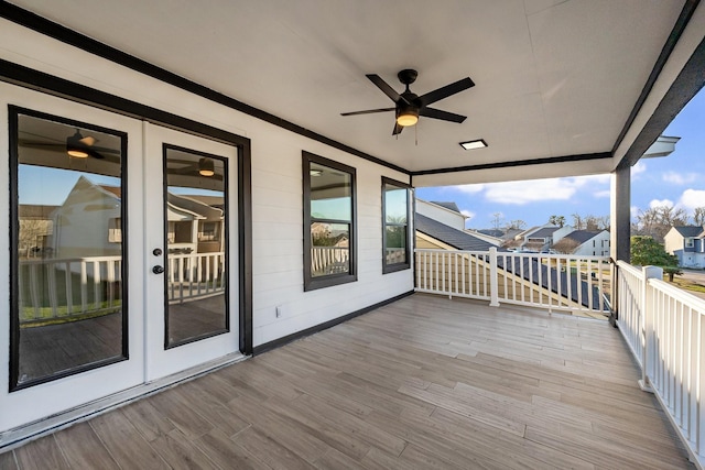 wooden terrace featuring french doors, a residential view, and a ceiling fan