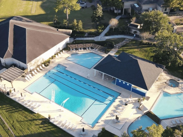 community pool featuring fence and a patio