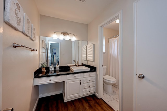 bathroom with vanity, toilet, and wood finished floors