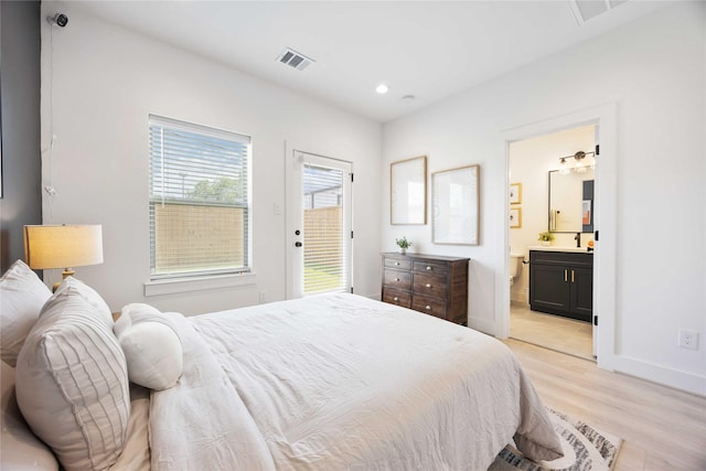 1909 Johanna Dr, Houston, TX 77055 - bedroom with light wood-type flooring, baseboards, ensuite bath, recessed lighting, and access to outside