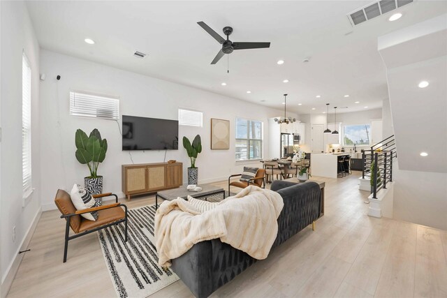 1909 Johanna Dr, Houston, TX 77055 - living room with healthy amount of natural light, a ceiling fan, light wood finished floors, recessed lighting, and stairway