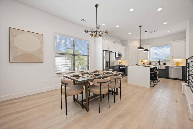 1909 Johanna Dr, Houston, TX 77055 - dining room with light wood-style flooring, a chandelier, recessed lighting, and baseboards
