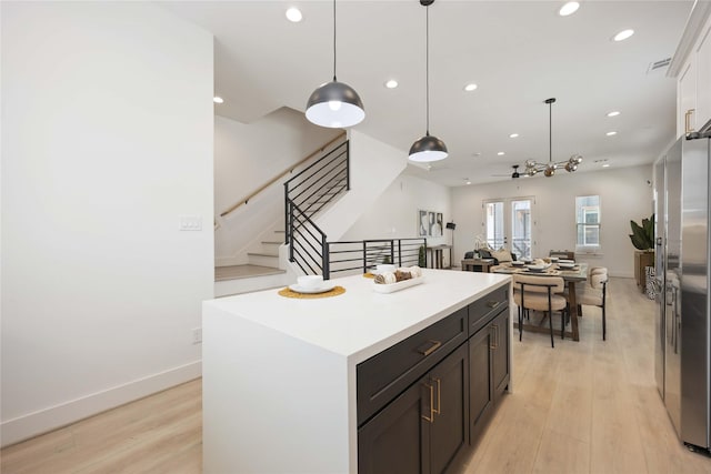 1909 Johanna Dr, Houston, TX 77055 - kitchen featuring recessed lighting, a center island, light wood finished floors, light countertops, and pendant lighting