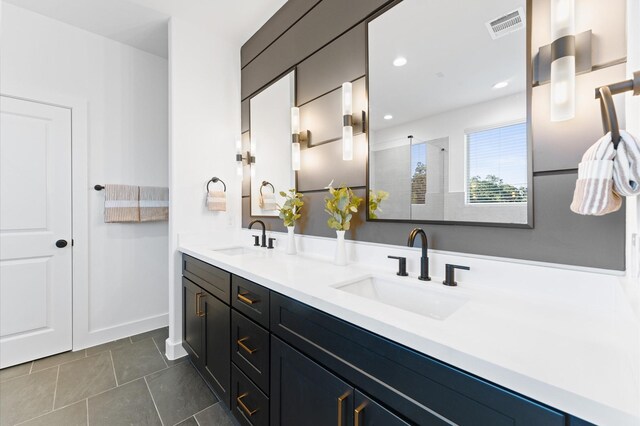 1909 Johanna Dr, Houston, TX 77055 - bathroom with double vanity, a tile shower, tile patterned flooring, and recessed lighting