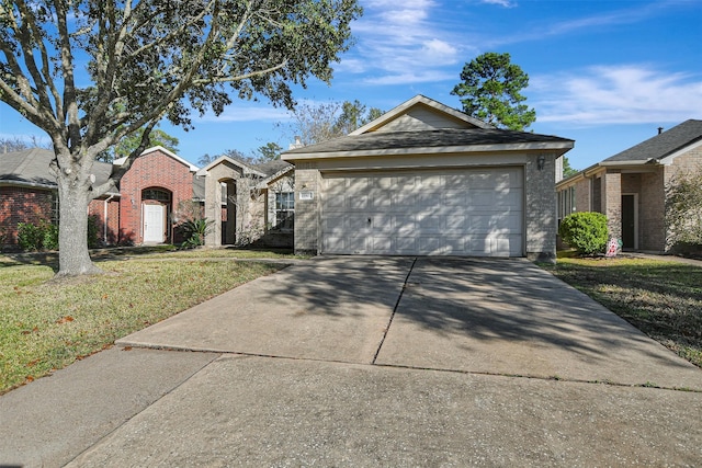 single story home featuring driveway, an attached garage, a front yard, and brick siding