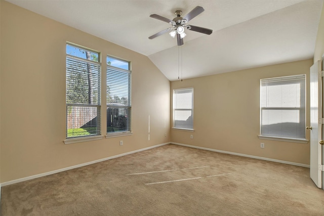 empty room featuring vaulted ceiling, ceiling fan, light carpet, and baseboards