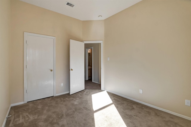 unfurnished bedroom featuring carpet floors, visible vents, and baseboards