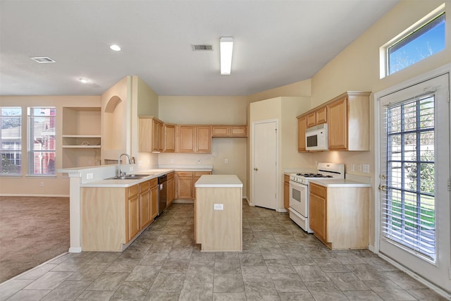 kitchen with white appliances, light countertops, a kitchen island, and a sink