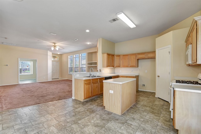 kitchen featuring light countertops, open floor plan, a kitchen island, a sink, and white appliances