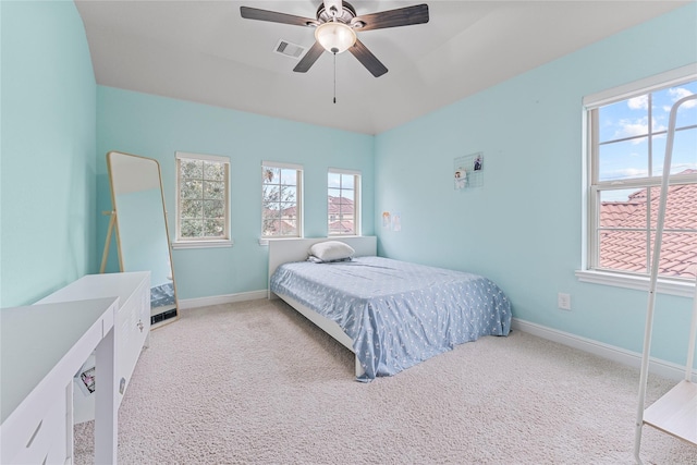 bedroom featuring light carpet, visible vents, and baseboards