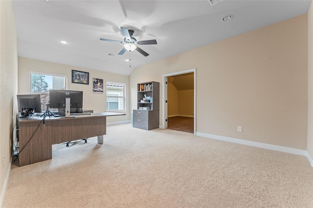 home office featuring ceiling fan, baseboards, a wealth of natural light, and light colored carpet