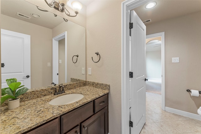 bathroom with baseboards, visible vents, tile patterned flooring, and vanity