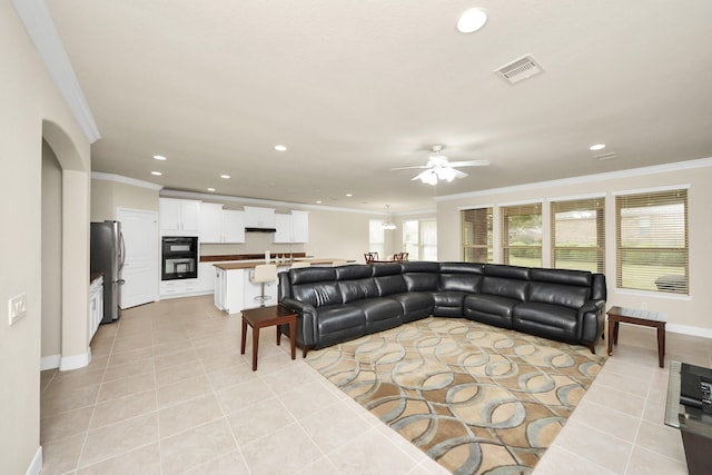 living area with light tile patterned floors, recessed lighting, visible vents, and ornamental molding