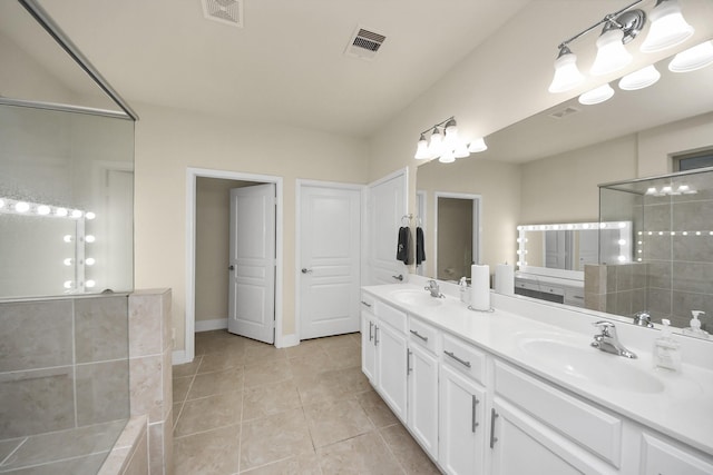 full bath featuring tile patterned flooring, visible vents, and a sink