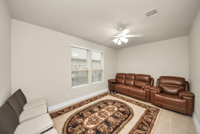 living area featuring visible vents, ceiling fan, baseboards, and light tile patterned floors