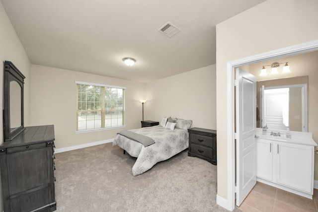 bedroom with light tile patterned floors, baseboards, visible vents, and light colored carpet