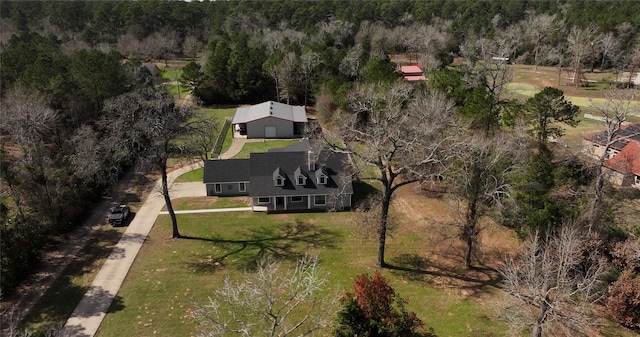 birds eye view of property featuring a wooded view