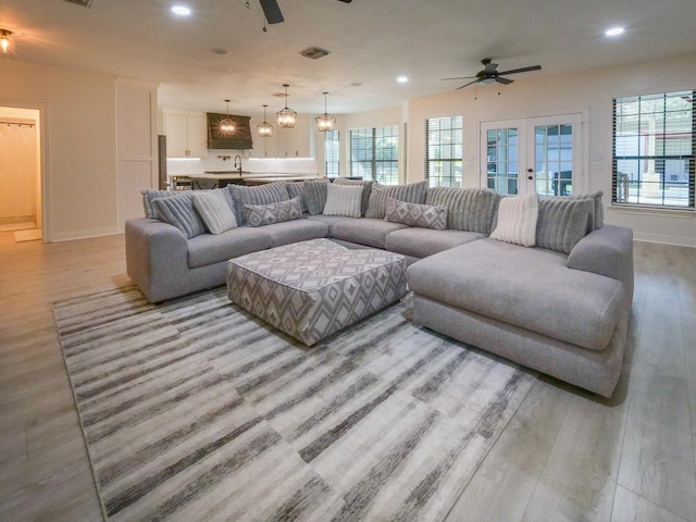 living area featuring ceiling fan, light wood-type flooring, and recessed lighting