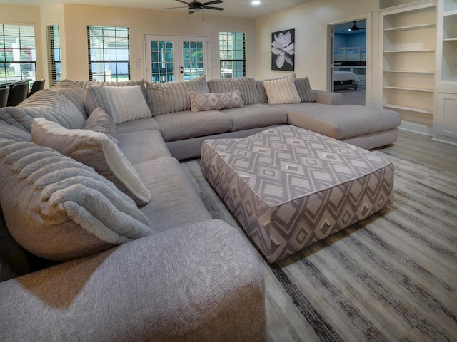 living area featuring wood finished floors, a ceiling fan, and french doors