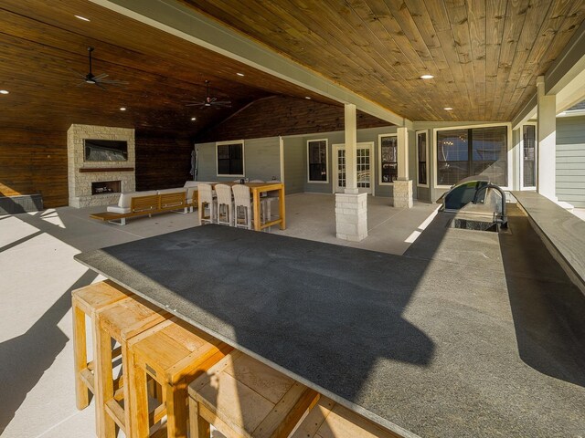 view of patio featuring ceiling fan and exterior fireplace