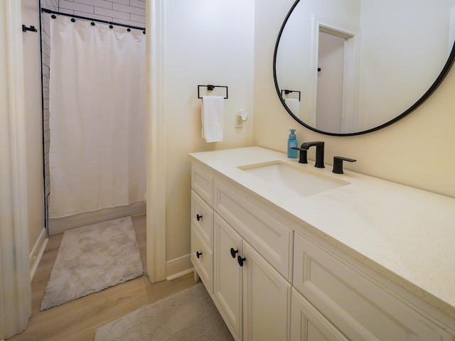 full bath with vanity and wood finished floors