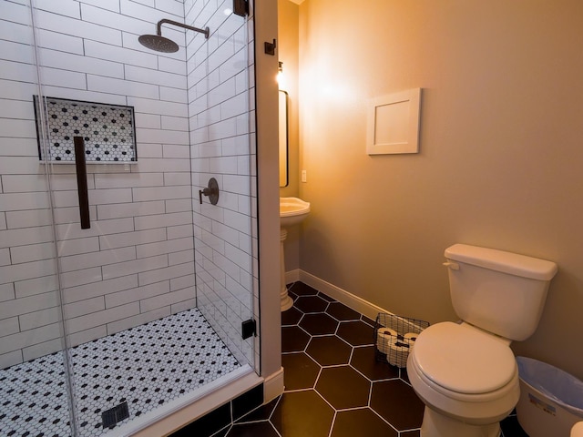 full bathroom with baseboards, a stall shower, toilet, and tile patterned floors