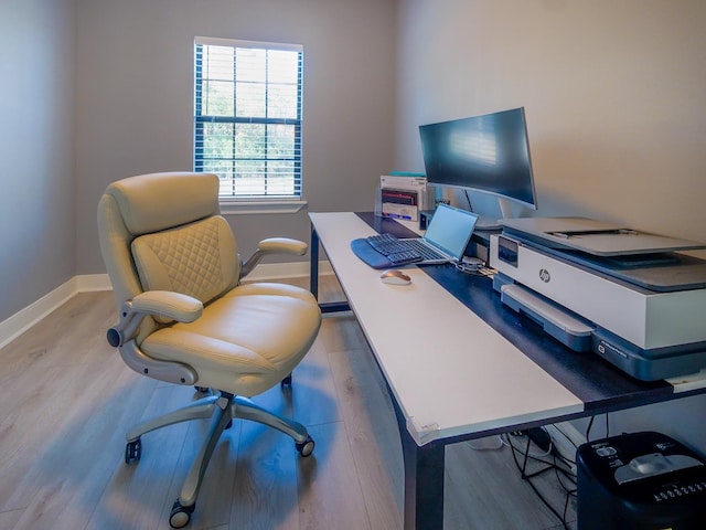 home office featuring baseboards and wood finished floors