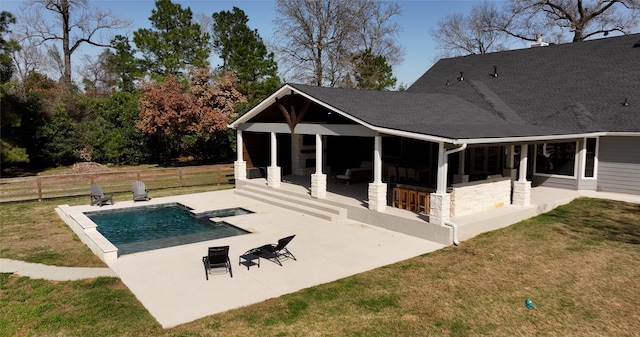 rear view of house featuring a yard, a patio area, fence, and a fenced in pool