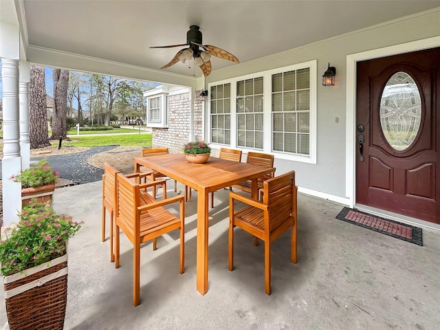 view of patio / terrace with a porch, outdoor dining area, and a ceiling fan