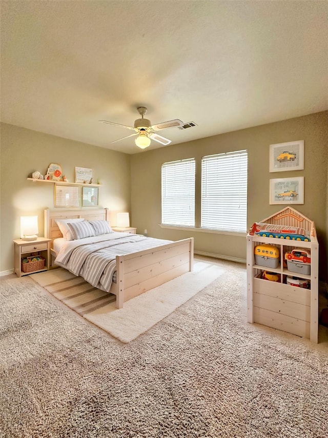 carpeted bedroom with visible vents and ceiling fan