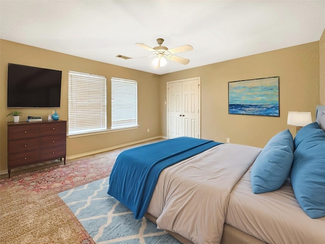 bedroom featuring a ceiling fan, carpet flooring, visible vents, and baseboards