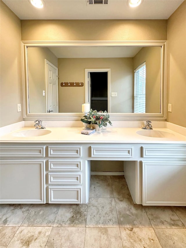 full bathroom featuring double vanity, a sink, and visible vents