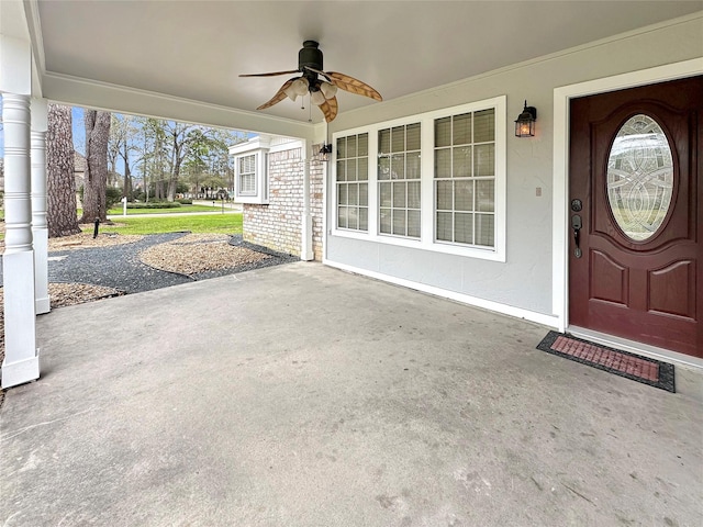 property entrance with ceiling fan, brick siding, and a porch