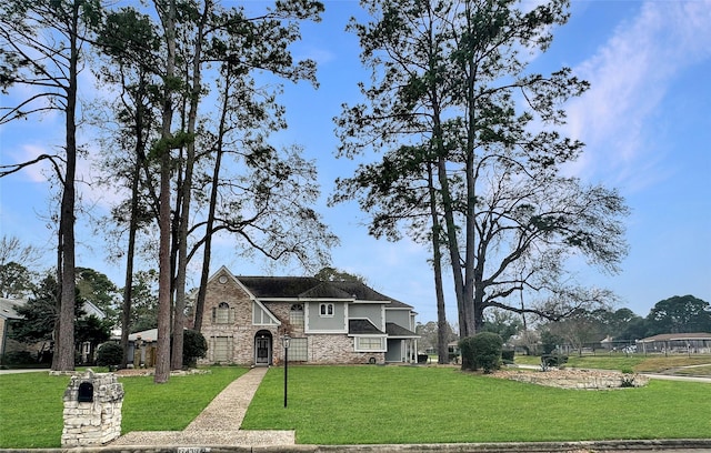 tudor home with stone siding and a front lawn