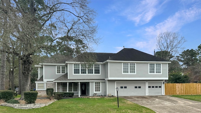 view of front of property featuring an attached garage, fence, a front lawn, and stucco siding