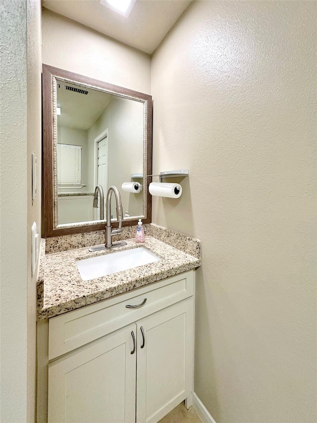 bathroom with vanity and baseboards