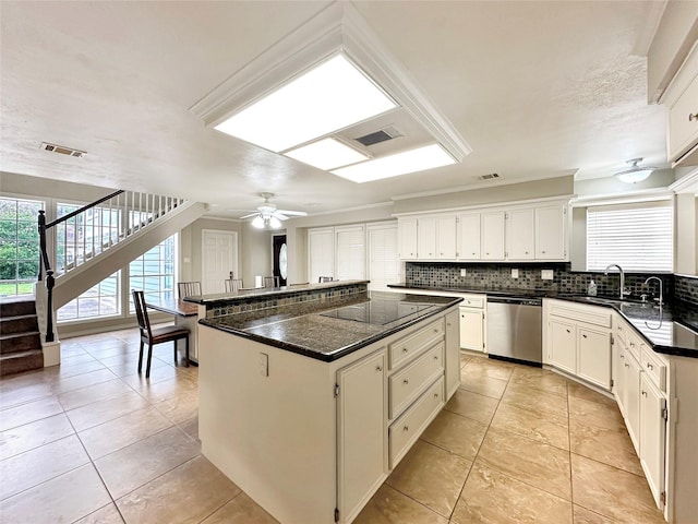 kitchen with visible vents, decorative backsplash, stainless steel dishwasher, a sink, and black electric cooktop