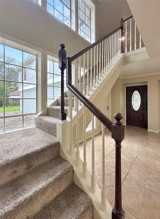 staircase with a towering ceiling