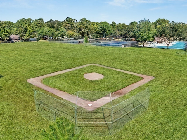 view of community with a pool and a yard