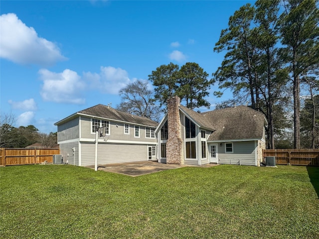 back of property with cooling unit, a fenced backyard, a patio, and a lawn