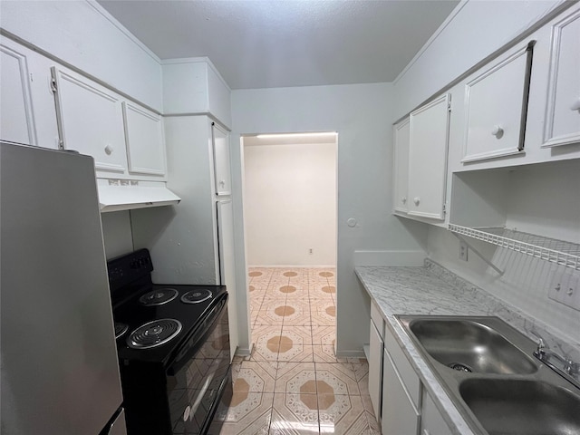 kitchen featuring electric range, white cabinets, freestanding refrigerator, under cabinet range hood, and a sink