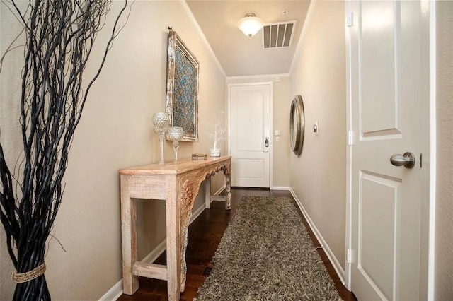 entryway with dark wood-style floors, visible vents, and baseboards