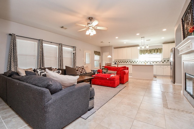 living area with ceiling fan, light tile patterned flooring, visible vents, and recessed lighting