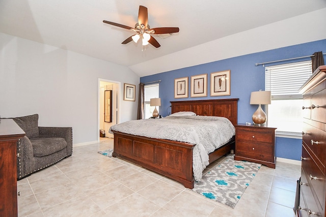 bedroom with a ceiling fan, light tile patterned flooring, vaulted ceiling, and baseboards